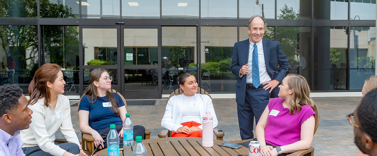 Dean Richard Freer converses with a group of students in Bacardi Plaza 