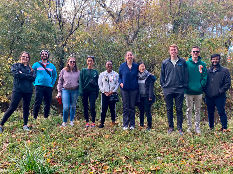 Students stand in a row in a field